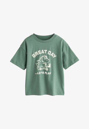 Zelena pamučna majica s okruglim izrezom, kratkih rukava, s bijelim grafičkim natpisom "GREAT DAY" i crtanim dinosaurom na romobilu.