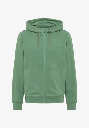 Zielona bluza z kapturem zapinana na zamek, wykonana z miękkiego materiału. Posiada kaptur, sznurki ściągające oraz boczne kieszenie. Strukturalne wykończenie z prążkowanymi mankietami i pasem.