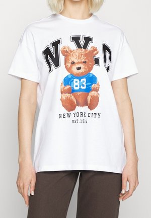 Weißes T-Shirt mit einer Grafik eines braunen Teddybären in einem blauen Shirt mit der Nummer 83, darüber steht "NYC" und darunter "New York City".