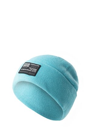 Light blue knit beanie with a ribbed texture, featuring a black fabric label with text. The design is simple and fitted.