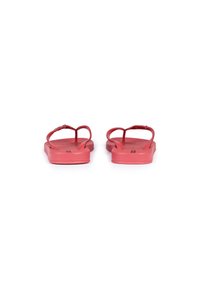 Red flip-flops with a textured footbed and thin straps, featuring a flat sole and a simple design. Suitable for casual wear.