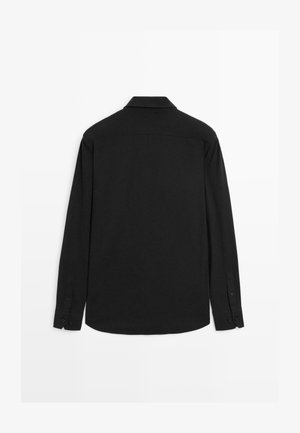 Long-sleeve black shirt featuring a classic collar, buttoned cuffs, and a smooth texture; back view shows a straight hemline and subtle seams.