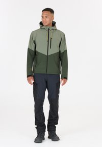 Water-resistant jacket in grey and dark green, featuring a zippered front, adjustable hood, and black pants with cargo pockets and reinforced accents.