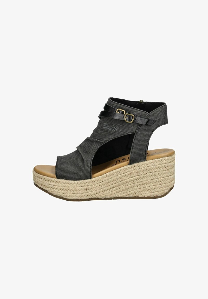 Black canvas wedge sandal with a textured woven jute outsole, side buckle, and an open toe design. Features crisscross straps and cutouts.