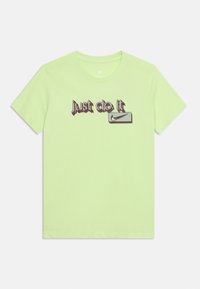 Ανοιχτό πράσινο κοντομάνικο μπλουζάκι με στρογγυλή λαιμόκοψη, με στυλιζαρισμένο κείμενο "Just do it" και λογότυπο Nike με σχήμα φτερού σε σκούρο μωβ μπροστά.