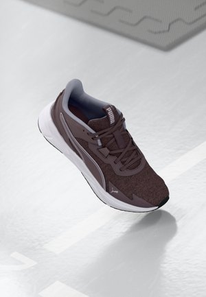 Dark brown athletic shoe with a textured knit upper, gray accents, white sole, and a logo on the heel and side. Lightweight design.