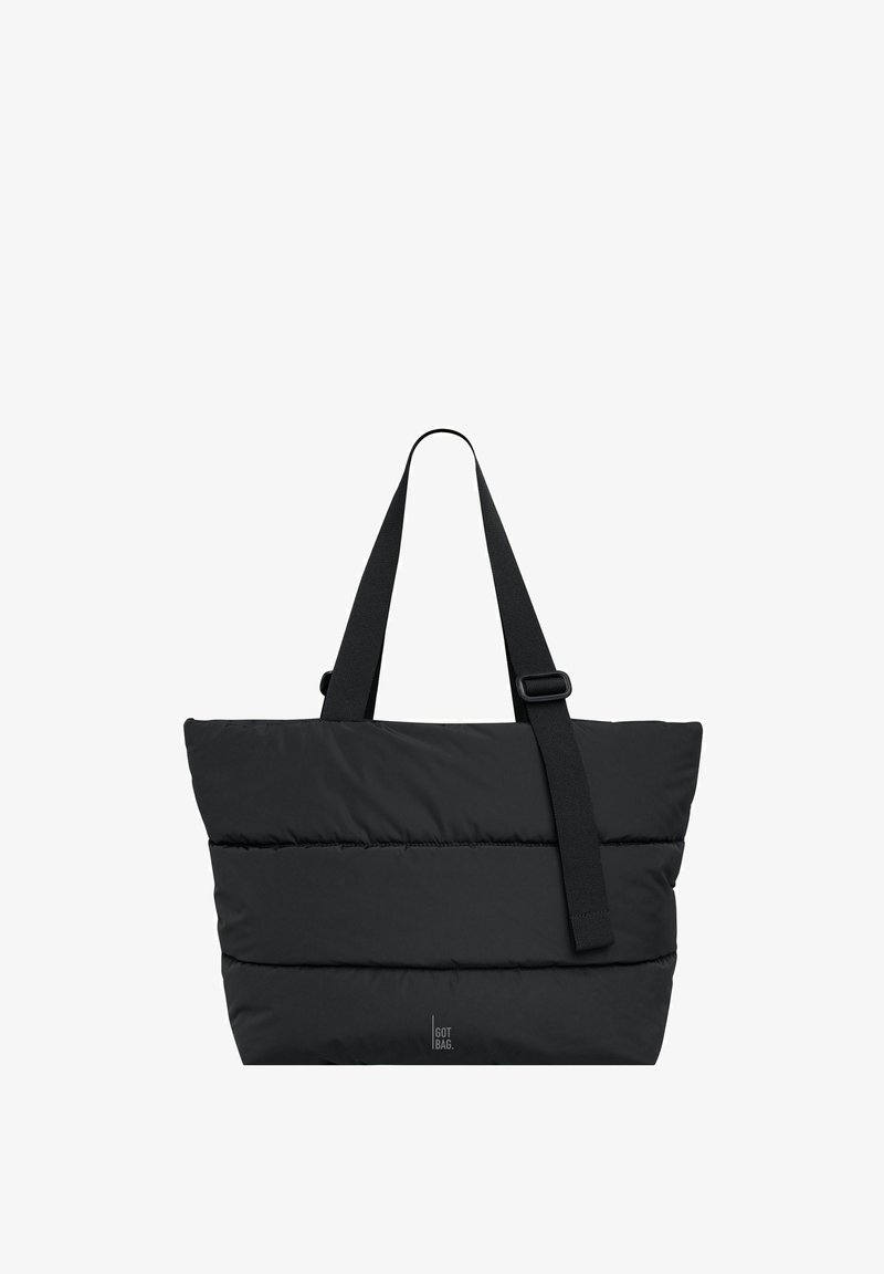 Schwarze, gepolsterte Tragetasche mit zwei Schulterriemen und verstellbarem Umhängegurt, kleines "GOT BAG"-Logo nahe am Boden.