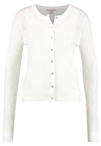 Vit kavaj med långa ärmar och ett mönstrat spetsdesign, ribbade muddar och fåll, samt sex dekorativa knappar framtill.