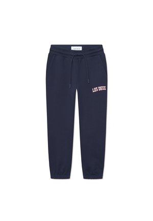 Navy Sweatpants mit elastischem Bund und Kordelzug. Mit seitlichen Taschen und einem pinken Logo "LES DEUX" am linken Oberschenkel. Dehnbare, abgepuffte Knödel.