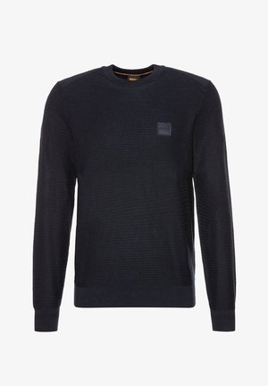 Pull noir texturé à manches longues avec col rond, poignets et ourlet côtelés, avec un petit patch logo carré sur la poitrine gauche.