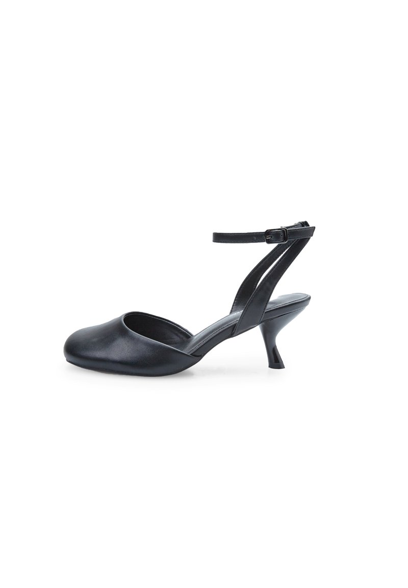 Black leather slingback shoe with a rounded toe, thin ankle strap, and a 3-inch cone heel. Smooth texture with minimalist design.