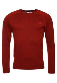 Felpa rossa a maglia realizzata in materiale morbido, con collo rotondo, maniche lunghe e un piccolo logo sul petto.