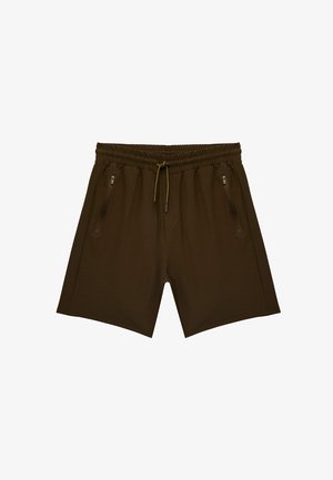 Bruine sportshorts van gladde stof. Voorzien van een elastische tailleband, trekkoord en twee ritszakken aan de zijkanten.