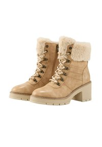 Beige nepleren enkellaarsjes met een getextureerde fake fur kraag, vetersluiting aan de voorkant en een chunky, gegroefd hak. Gedetailleerde stiksels zichtbaar.