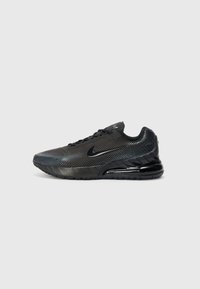 Black athletic shoe with mesh upper, reflective accents, and a cushioned sole. Features a rounded toe and a lace-up design.