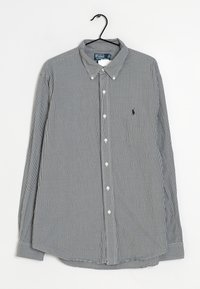 Camisa de manga larga con estampado de cuadros en blanco y negro, cuello abotonado, botones en la parte delantera y pequeño logo bordado en el pecho.