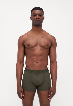 Dunkelgrüne Boxershorts mit einem kontrastierenden Bund, der den Markennamen trägt. Aus glattem Stoff gefertigt, bieten sie eine enganliegende Passform und ein nahtloses Design.