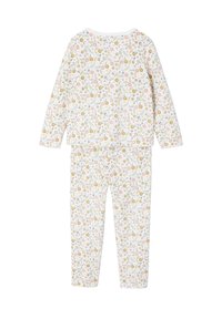 Floral print pajama set made of soft cotton. Features long sleeves and pants, primarily white with multicolored flowers and green leaves.