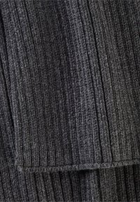 Dark gray ribbed textile with vertical lines, featuring a soft, textured surface and visible knit pattern, showcasing a folded edge.