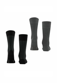 Quatre paires de chaussettes en noir et gris foncé, avec des motifs texturés et des talons renforcés. Le matériau semble tricoté avec des couleurs contrastantes.