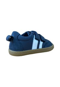 Zapatillas de deporte azul marino de cuero y ante, con rayas blancas, tiras de velcro, suela de goma y un pequeño lazo en el talón.