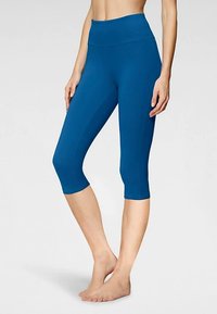 Modre kapri legice iz raztegljivega materiala, z visokim pasom in gladko teksturo. Brez vidnih vzorcev ali kovinskih dodatkov.