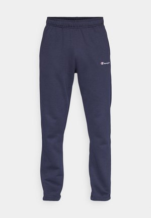 Pantalones de chándal azul marino con cintura elástica, puños fruncidos y un pequeño logotipo bordado en el muslo izquierdo. Hechos de una tela suave.