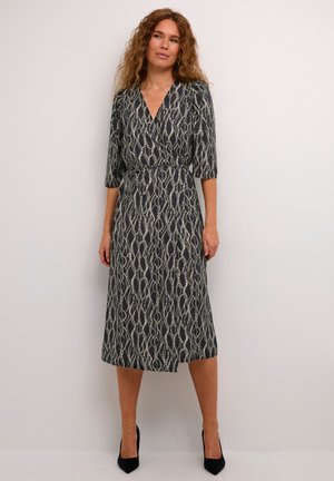 Wrap dress with a dark navy background and a white wavy pattern. Features three-quarter sleeves, a cinched waist, and a flowing skirt.