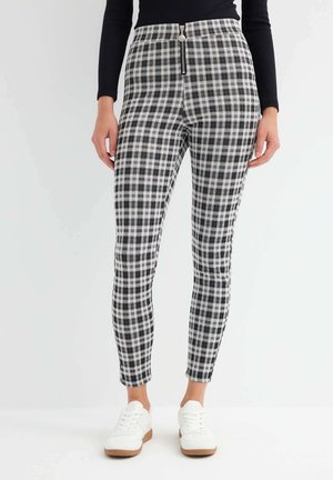 DE CUADROS CON CREMALLERA - Leggings - black