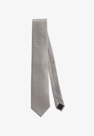 Graue Krawatte mit einem wiederholten kreisförmigen Muster, aus glattem Stoff; schmal, mit einer spitzen Enden und einem schwarzen Akzent auf der Rückseite.