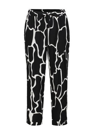 Pantalons à motifs noir et blanc avec un design imprimé de girafe, taille élastique et coupe décontractée avec des ourlets courts. Texture de tissu douce.