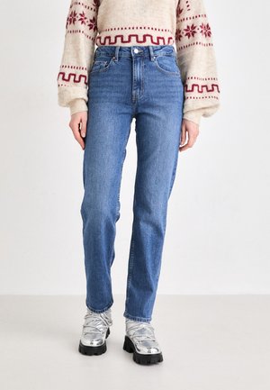 Light blue high-waisted jeans with straight legs, made of denim. Features classic five-pocket design and subtle fading in the fabric.