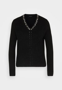 Pull en maille noir à manches longues avec col en V orné d'embellissements argentés en forme de feuilles le long de l'encolure et au centre devant.