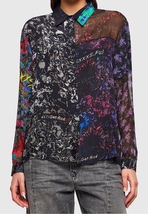 Collagestil langærmet skjorte med blandede blomsterprint, gennemsigtigt højre ærme, klare farver og en sort krave, båret sammen med grå jeans.