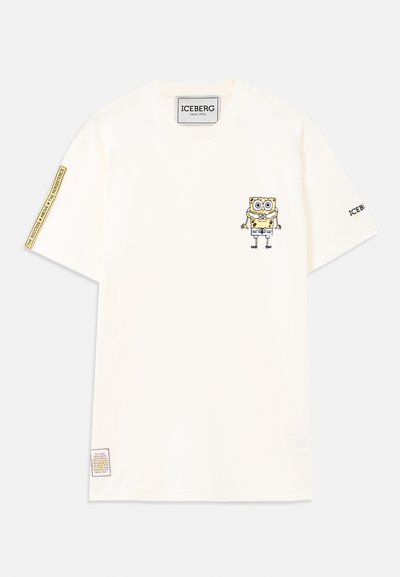 Vit kortärmad T-shirt med en liten tecknad SpongeBob-grafik på vänster bröst och textlappar på höger ärm och nederkant.