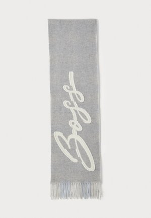 Gray woven scarf with white embroidered script. Features fringed edges and a soft texture. Narrow, elongated rectangular shape.