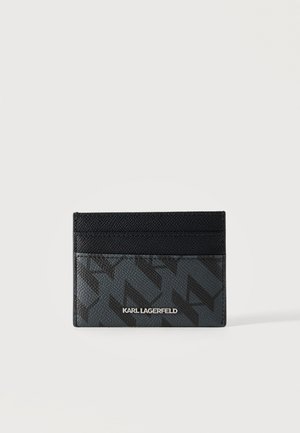 Tarjetero texturizado en negro y gris oscuro con logo y patrón geométrico, con tres ranuras para tarjetas sobre un fondo claro y liso.