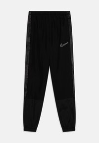 Melnas Nike sporta bikses ar elastīgu jostasvietu, šaurām kājām un tekstūrētām sānu pusēm, kurās ir monohroms logotips. Gluda auduma ar smalku rakstu.