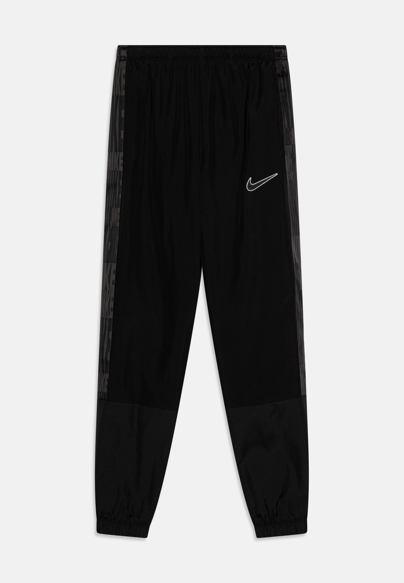 Melnas Nike sporta bikses ar elastīgu jostasvietu, šaurām kājām un tekstūrētām sānu pusēm, kurās ir monohroms logotips. Gluda auduma ar smalku rakstu.