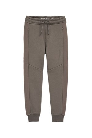 Šedé tepláky s elastickým pasem, šňůrkou na stažení, bočními kapsami a strukturovanými bočními panely. Hladká tkanina s žebrovanými manžetami na kotnících.