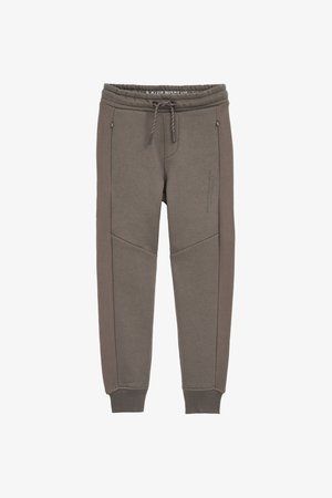 Pelēki sporta bikses ar elastīgu jostasvietu, saites auklu, sānu kabatām un tekstūrētām sānu paneļiem. Gluda audums ar ribinātām aprocēm pie potītēm.