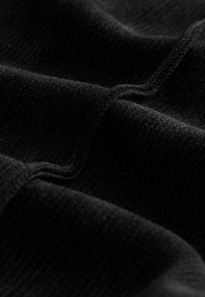 Close-up of black textured fabric with visible stitching and folds, highlighting the material’s weave and soft surface.