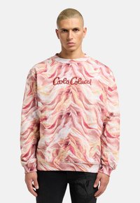 Langarm-Sweatshirt mit einem wellenförmigen Muster in Pink und Creme, versehen mit einem gestickten "Carlo Colucci"-Logo auf der Brust. Material-Mix aus Baumwolle.