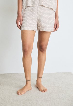 Beige mönstrade sovshorts med avslappnad passform, med en geometrisk design, mjukt tyg och en fåll som slutar vid mitten av låret.