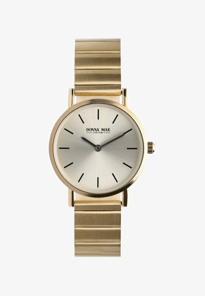 Polshorloge in goudtint met een zilverkleurige zonnestraalwijzerplaat, zwarte uurmarkeringen en een geborstelde metalen armband met horizontale ribbels.