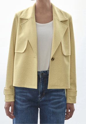 Jacka i konstläder - mottled light yellow