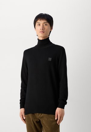 Jersey de cuello alto negro en tejido de punto, con un pequeño parche de la marca en el pecho, mangas largas y un dobladillo recto.