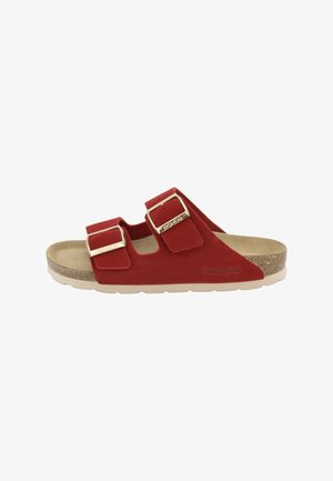 Red suede sandal with two adjustable straps, gold-tone buckles, cork footbed, and beige rubber sole. Features a flat design for comfort.
