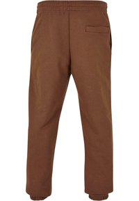 Bruine katoenen sweatpants met een elastische tailleband, zijzakken en een achterzak. De boorden zijn aangesloten voor een getailleerde uitstraling.
