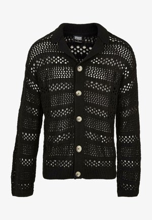 Cárdigan negro con un diseño de punto abierto. Presenta un cuello, mangas largas y seis grandes botones redondos en la parte delantera.